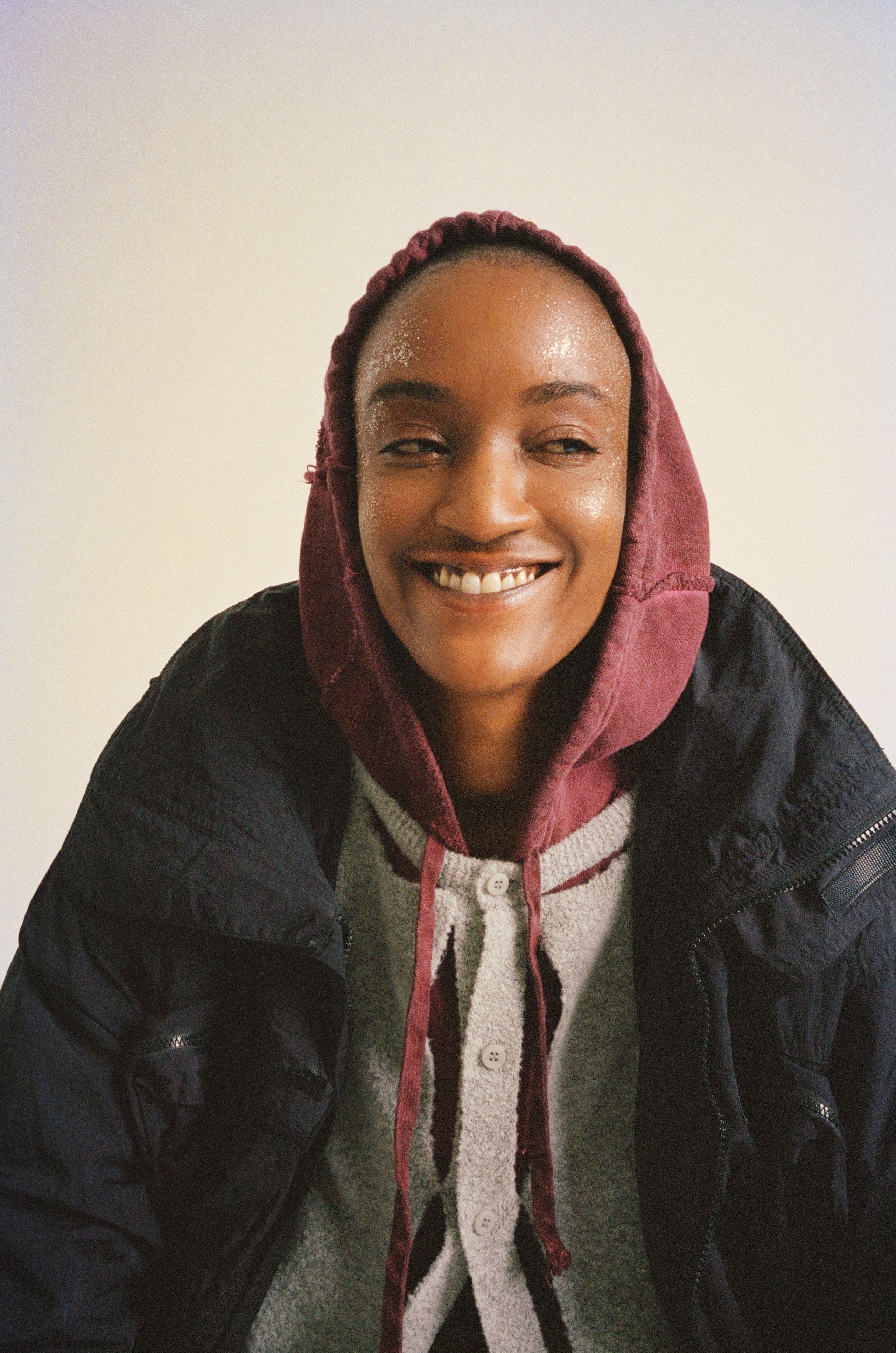 Syd smiling in a red hood